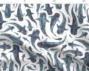 May include: A white background with a repeating pattern of blue and black whale sharks. The whale sharks are stylized and have a dotted pattern.
