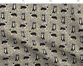 May include: A seamless pattern featuring black and white border collies on a light brown background. The dogs are in various poses, including sitting, standing, and running. The pattern also includes bones, dog bowls, and tennis balls.