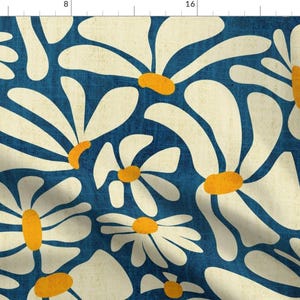 May include: A seamless pattern featuring stylized white daisies with yellow centers on a deep blue background. The daisies are arranged in a repeating pattern, creating a modern and abstract floral design.