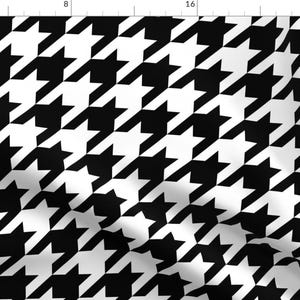 May include: Black and white houndstooth pattern fabric. The pattern is a classic design with a repeating motif of interlocking shapes.
