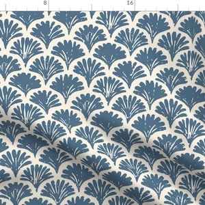 May include: A seamless pattern featuring a repeating design of blue stylized fan shapes on a cream background.