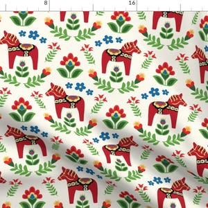 May include: A white background with a repeating pattern of red, yellow, green, and blue stylised horses and flowers. The horses are a traditional Swedish design called a Dala horse.