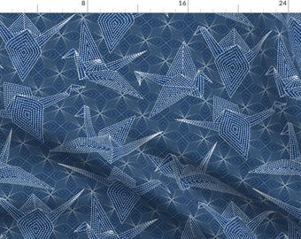 May include: A blue fabric with a white pattern of origami cranes. The cranes are made up of small white dots that create a geometric design.