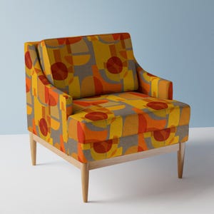 May include: A mid-century modern armchair with a geometric pattern in shades of orange, yellow, and gray. The chair has a wooden frame and legs.