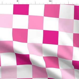 May include: A checkered pattern fabric with alternating squares of pink and white. The fabric has a slight wave pattern.