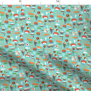 May include: A teal blue fabric with a repeating pattern of sushi, chopsticks, and other Japanese food items. The sushi is depicted as cartoon characters with smiling faces.