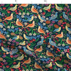 May include: A dark blue fabric with a repeating pattern of colorful birds and flowers. The birds are in various shades of orange, yellow, blue, and green. The flowers are in shades of pink, red, and white.