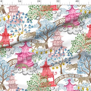 May include: A white fabric with a repeating pattern of pink and red pagoda-style buildings, green trees, and leopard print animals. The background is white with gray clouds.