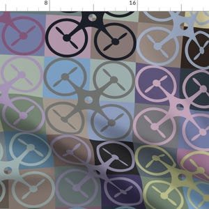 May include: A repeating pattern of drone silhouettes in various colors, including blue, green, purple, pink, and brown. The drones are arranged in a grid pattern, with each drone overlapping the next.
