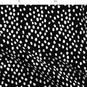 May include: Black and white fabric with a repeating pattern of white polka dots on a black background.
