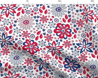 May include: A seamless pattern featuring red, white, and blue stylized flowers on a white background. The flowers are arranged in a random pattern and are of varying sizes.