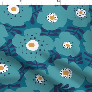 May include: Teal blue floral pattern with white and yellow accents. The pattern features large stylised flowers with white centres and yellow dots. The background is a deep teal blue.