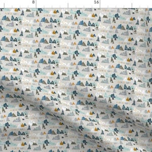 May include: A seamless pattern featuring a repeating design of stylised mountains in shades of blue, grey, and white on a light grey background. The mountains are accented with small yellow and orange details.