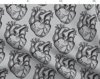 May include: A seamless pattern featuring a repeating design of anatomical hearts in black and white on a light gray background.