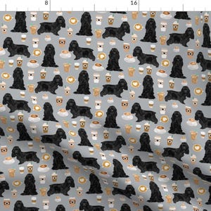 May include: A seamless pattern featuring black American Cocker Spaniels and coffee cups on a light grey background. The dogs are in various poses, some sitting, some standing, and some looking at the viewer. The coffee cups are filled with coffee and have a brown and white design.