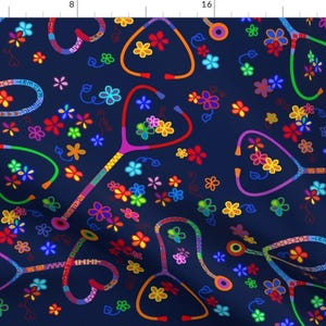 May include: A navy blue fabric with a colorful pattern of stethoscopes and flowers. The stethoscopes are made up of different colored beads and the flowers are in various shades of pink, red, yellow, orange, green, and blue.