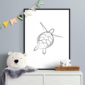 May include: A black and white line drawing of a sea turtle swimming, printed on a white background and framed in a black frame.