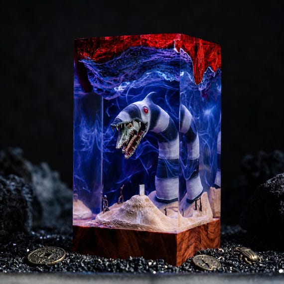 A hand-cast resin diorama of Beetlejuice's iconic sandworm — the kind of desk piece that stops every visitor mid-sentence.