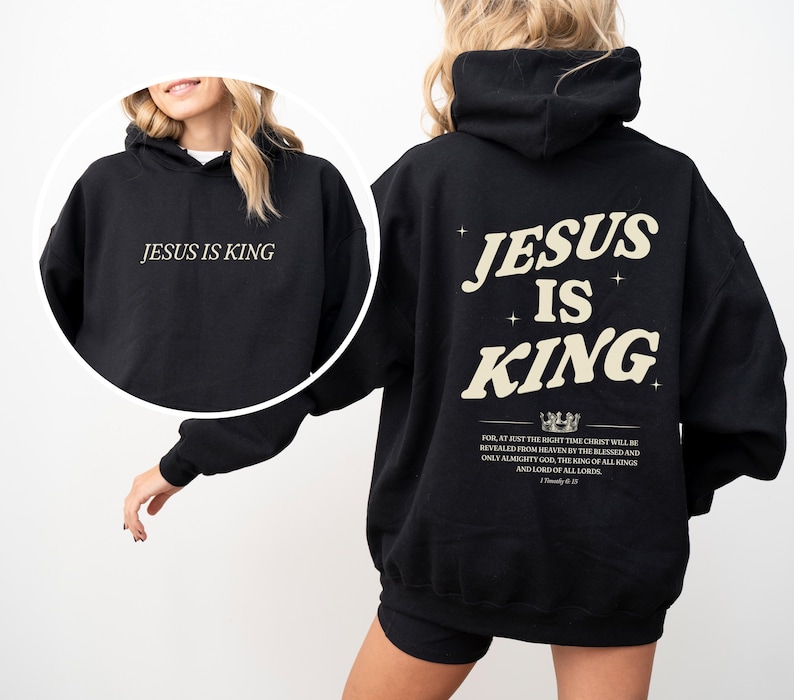 May include: Black hoodie with the text "JESUS IS KING" on the front and back. The back design includes the text "JESUS IS KING" with a crown graphic and a Bible verse. The hoodie is a casual, comfortable garment.