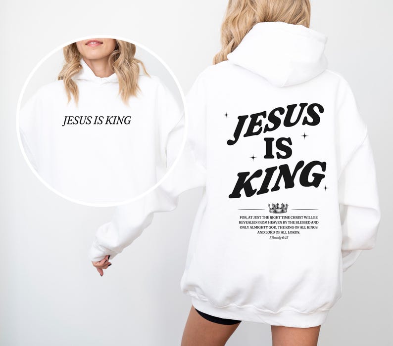May include: White hoodie with the text "JESUS IS KING" on the front and back. The back design includes the words "JESUS IS KING" with a crown graphic and a Bible verse. A casual, religious-themed apparel item.