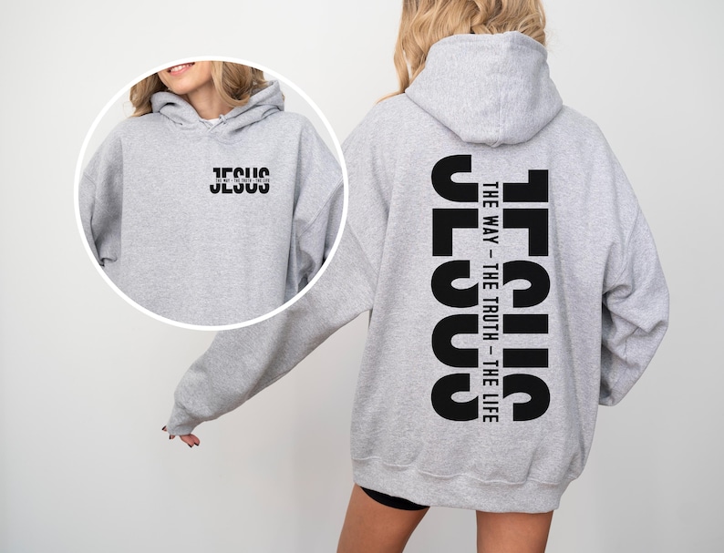 May include: A light grey hoodie with the word "JESUS" printed in black on the front and back. The back of the hoodie also features the text "THE WAY - THE TRUTH - THE LIFE" in black. The hoodie has a hood and long sleeves.