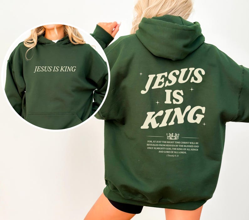 May include: A dark green hoodie with the text "JESUS IS KING" printed on the front and back. The back of the hoodie features the same text in a larger font, along with a crown graphic and a Bible verse.