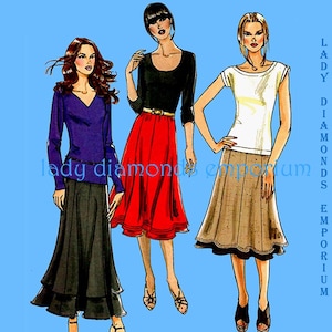 May include: Illustration of three women in different outfits. One wears a purple top and black skirt, another a black top and red skirt, and the third a white top and tan skirt. The text "LADY DIAMONDS EMPORIUM" is on the right side of the image.