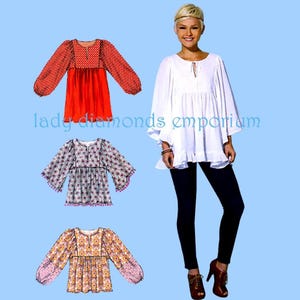 May include: An image featuring three different patterned blouses and a woman wearing a white blouse with a ruffled hem. The blouses have long sleeves and various patterns, including polka dots and floral designs. The text "lady diamonds emporium" is visible.