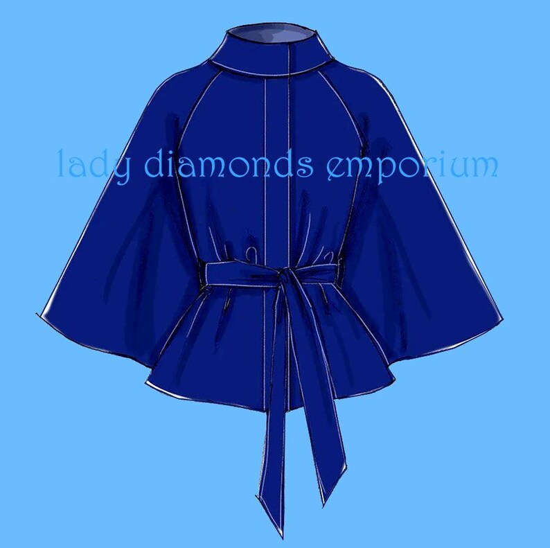 May include: A royal blue cape with a high collar and a tie belt. The cape has a flowing design with wide sleeves. The text "lady diamonds emporium" is printed on the left side of the cape.