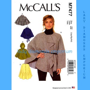 May include: McCall's sewing pattern M7477 with cape designs. The pattern includes different cape styles, such as a hooded cape and a belted cape. The image shows a woman wearing a grey cape. Size ZZ (Lrg-Xlg-XXl).