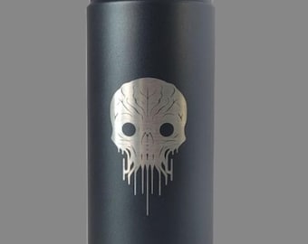 May include: Black insulated water bottle with a silver skull design. The bottle has a black handle and a silver logo near the bottom. The skull design has a unique, artistic style.