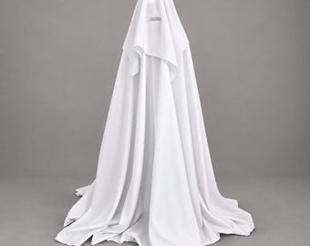 May include: A tall, conical structure draped in a solid white fabric that extends to the floor. The fabric features soft, vertical folds and drapes, creating a smooth, flowing silhouette that completely covers the underlying form from top to bottom.