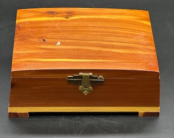 Vintage cedar wood trinket jewelry box, often referred to as a miniature cedar chest. 