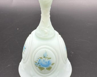 Vintage Fenton glass bell is crafted from satin blue glass and features a hand-painted blue rose design on a medallion.