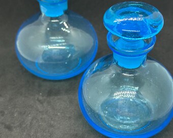 Vintage blue art glass vases features a rounded silhouette vanity bottles or perfume decanters with stoppers.