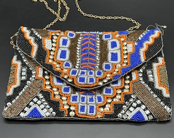 Anton Kraft geometric beaded clutch bag with a gold chain strap.