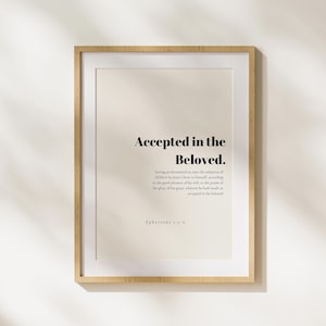 May include: A framed print with a beige background and black text that reads "Accepted in the Beloved."  The text is a quote from Ephesians 1:5-6.