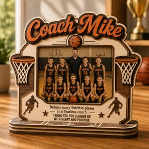 May include: Wooden basketball-themed photo frame with the words "Coach Mike" in orange. The frame holds a team photo and includes basketball hoops and the text: "Behind every fearless player is a fearless coach. Thank you for leading us with heart and purpose."