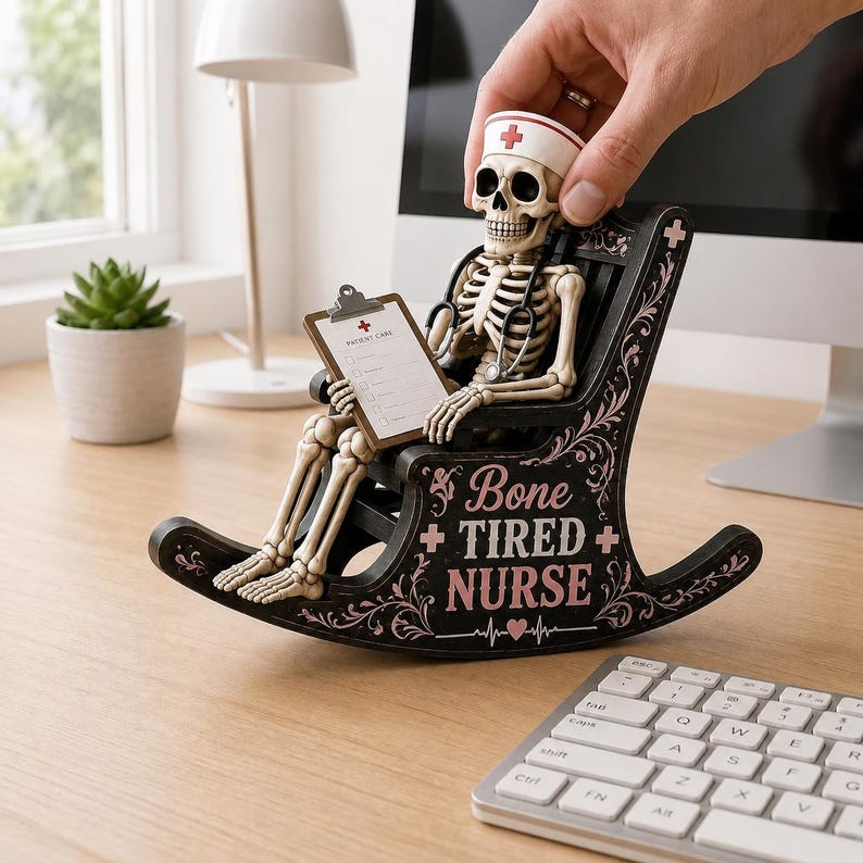 May include: A skeleton figurine wearing a nurse cap and stethoscope, sitting in a black rocking chair. The chair features decorative scrollwork, a small heart, and the text "Bone TIRED NURSE". The skeleton holds a clipboard labeled "PATIENT CARE".