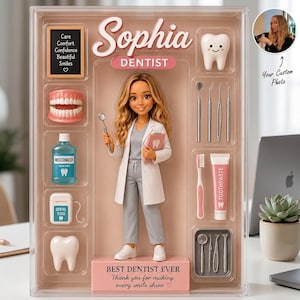 May include: A custom dentist doll set in a clear display box featuring a doll in a white coat, a model of teeth, mouthwash, dental floss, a toothbrush, toothpaste, and various dental tools. The box includes the text Sophia, Dentist, and Best Dentist Ever.