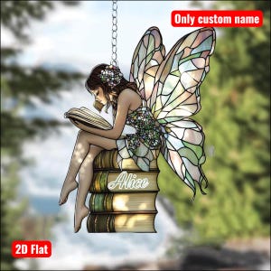 May include: A decorative 2D flat ornament featuring a fairy reading a book while seated on a stack of books. The fairy has stained glass style wings and the name "Alice" is on the books. The text "Only custom name" and "2D Flat" are also visible.