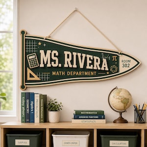 May include: A dark green pennant-shaped wall sign with a light-coloured rope hanger. The sign features the text MS. RIVERA and MATH DEPARTMENT in white lettering, along with graphics of a calculator, a triangle ruler, a star, and the pi symbol.