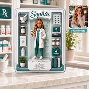 Könnte beinhalten: Eine Apothekerpuppe im weißen Kittel und türkisfarbener Kleidung, verpackt in einer Schachtel mit Zubehör wie Mörser, Medikamentenflaschen, Computer, Büchern und Tasche. Die Box trägt den Namen Sophia und den Text Best Pharmacist Ever.