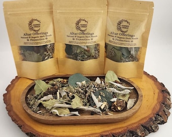 May include: Three brown paper bags with the text "Altar Offerings Natural & Organic Herb Blends Protection" on the front. The bags are filled with dried herbs and are sitting on a wooden surface.