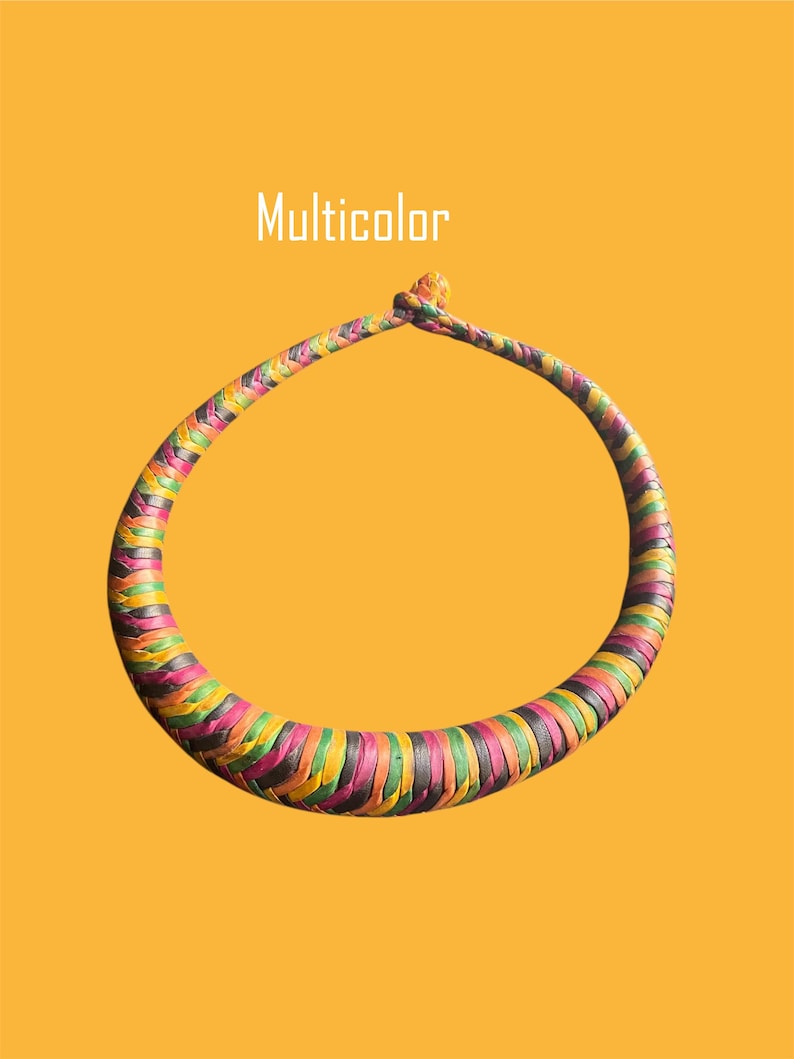 May include: A woven necklace in a circular shape, featuring a vibrant array of colors including pink, green, yellow, and black. The word "Multicolor" is displayed in white text above the necklace against a yellow background.
