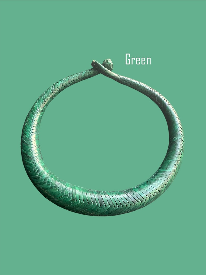 May include: A green, braided necklace with a textured surface. The necklace is circular and has a clasp at the top. The word "Green" is displayed in white text.