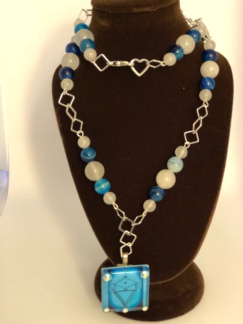 Two accent veve beads adornments. la Sirene Vodou Veve pendant with blue agate and moonstone beaded necklace