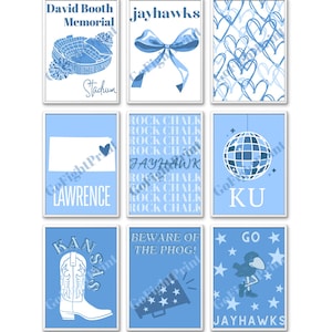 May include: Nine framed prints with blue and white designs. The prints feature images of a stadium, a bow, hearts, the state of Kansas, a cowboy boot, a disco ball, and text that says "Rock Chalk" and "Jayhawks".