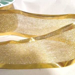 May include: Gold mesh ribbon with a gold satin edge. The ribbon has a sparkly finish.