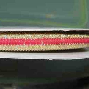 May include: Gold and red trim with a textured surface.